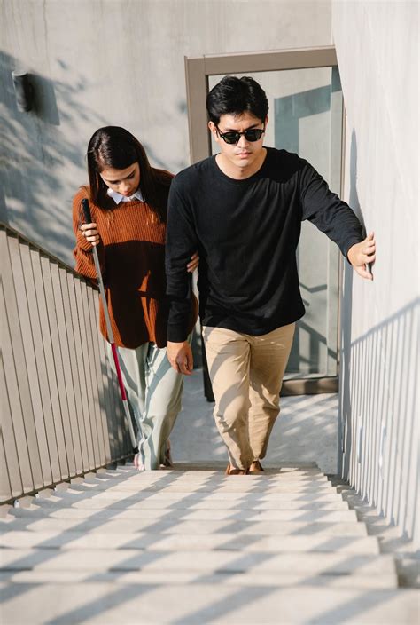 Photo of Woman Assisting Man to Walk Up the Stairs · Free Stock Photo