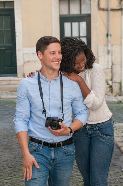 Casal interracial feliz andando na cidade Foto Grátis