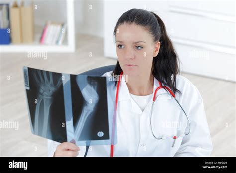 Doctor Looking At The X Ray Picture Of Hand Stock Photo Alamy