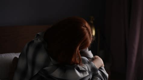 Depressed Asian Woman Sitting Alone On The Floor By The Window With