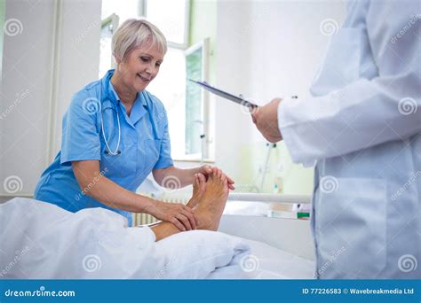 Nurse Giving Foot Treatment To Patient Stock Image Image Of Clipboard