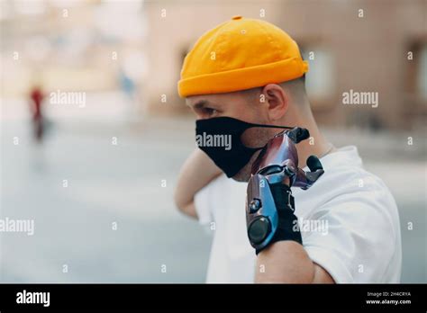 Young Disabled Man Put On Medical Protective Face Mask With Artificial