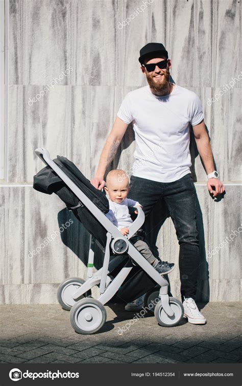 Father Walking With A Stroller And A Baby In The City Streets — Stock