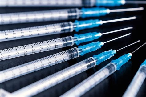 Premium Photo Medical Syringes Needle On Black Background Close Up