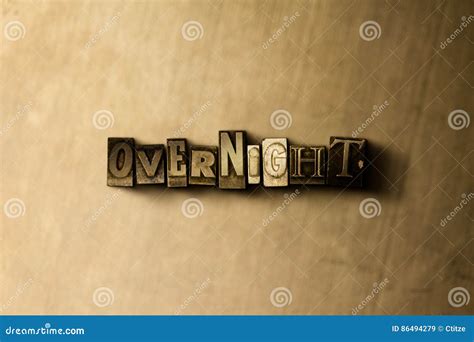 OVERNIGHT - Close-up of Grungy Vintage Typeset Word on Metal Backdrop Stock Image - Image of ...