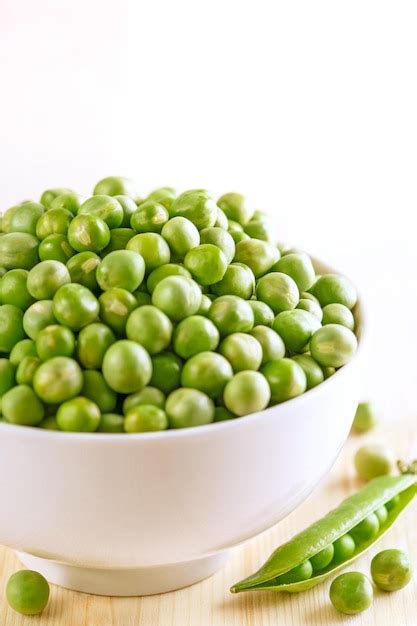 Premium Photo Close Up Of Green Peas In Bowl On Table Against White