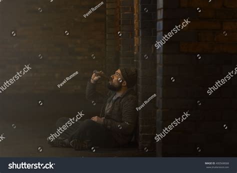 Homeless Man Drinking Alcohol On Backstreet Stock Photo 400568068