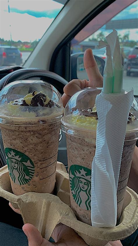 Two Cups Of Coffee Sitting On Top Of Each Other In The Back Seat Of A Car