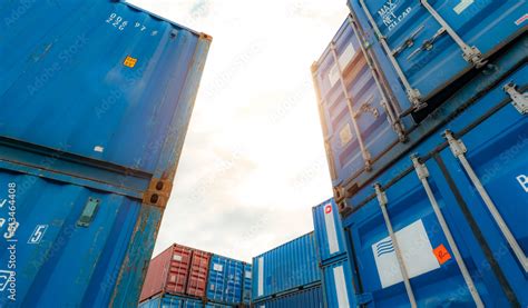 Blue And Red Logistic Container Against White Sky Cargo And Shipping