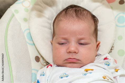 Cute newborn baby boy, sleeping in a swing Stock Photo | Adobe Stock