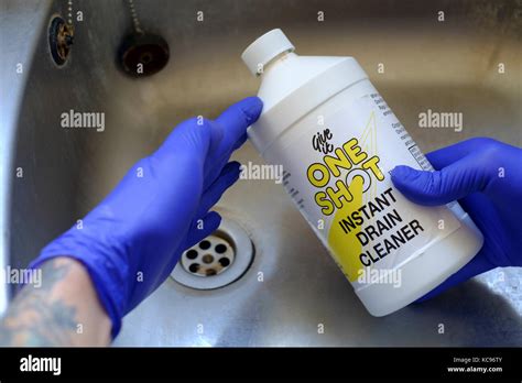 Man Wearing Protective Rubber Gloves Preparing To Use Sulphuric Acid