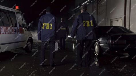 Premium Photo | Fbi agents work at the scene at night police car with lights and ambulance ...