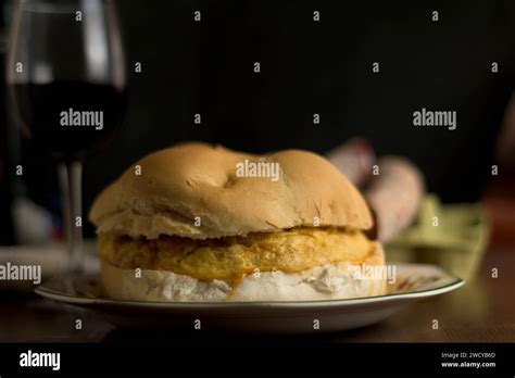 Potato Omelette Sandwich With Round Artisan Bread And Glass Of Wine