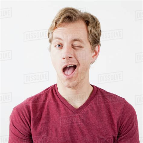 Portrait Of Man Winking Stock Photo Dissolve