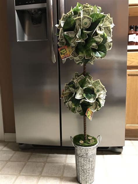 A Potted Plant With Money Growing Out Of It In Front Of A Stainless