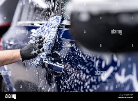 Foam on car body in manual car wash Stock Photo - Alamy