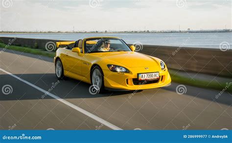 Yellow Honda S2000 Type S Driving Along Huge Lake Editorial