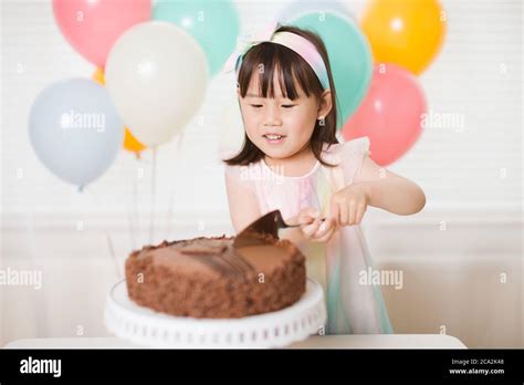 Girl Cutting Birthday Cake High Resolution Stock Photography and Images ...
