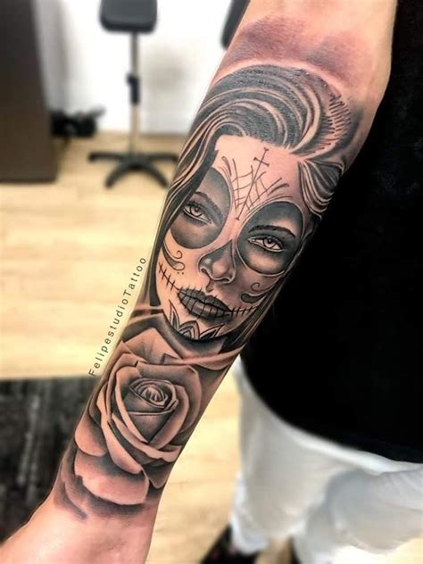 A Woman With A Skull And Rose Tattoo On Her Arm