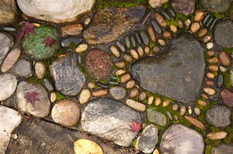 Rocks And Stones Are Arranged In The Shape Of A Heart With Leaves On