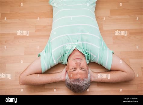 Mature Man Lying On Floor Stock Photo Alamy