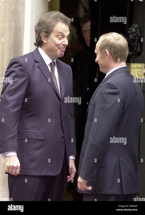 Prime Minister Tony Blair (L) greets Russian President Vladimir Putin ...