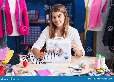 Young Woman Tailor Smiling Confident Using Sewing Machine At Sewing