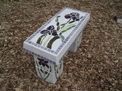 A Bench Made Out Of Tiles With Flowers Painted On The Top And Bottom