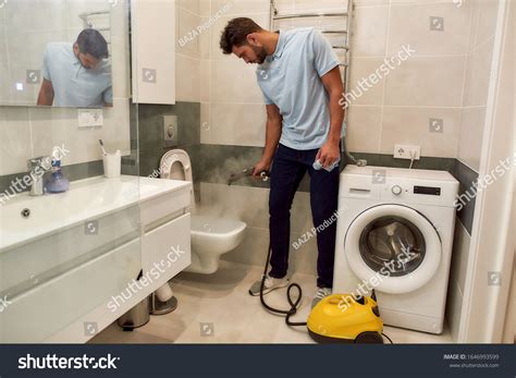 Young Caucasian Man Uniform Cleaning Toilet Stock Photo 1646993599