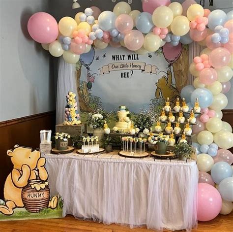 A Winnie The Pooh Birthday Party With Balloons And Desserts