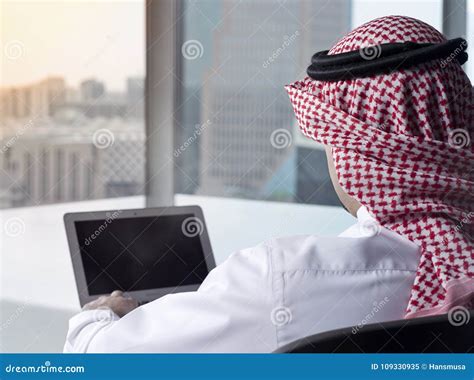 Saudi Arab Man Watching Laptop At Work Contemplating Stock Image