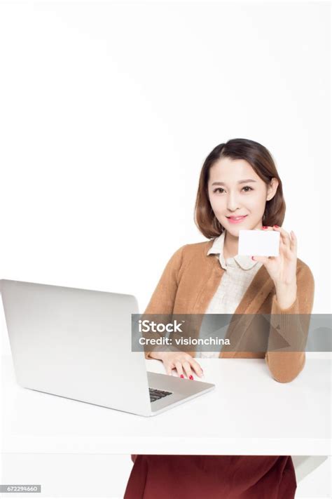 Chinese Female Student Sitting In A Classroom Surf The Internet Using