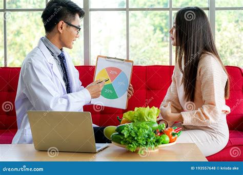 Asian Medical Doctor Advised Young Female Patient On Nutrition And