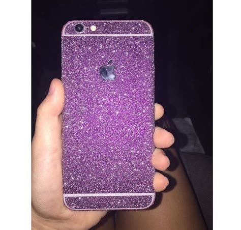 A Person Holding Up A Purple Iphone Case In Their Hand With Glitter On