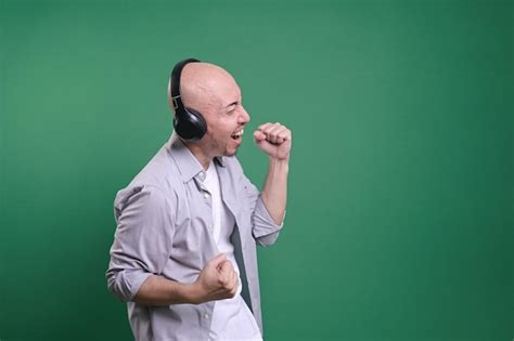 Premium Photo Side View Of Bald Man Listening Music With Headphones