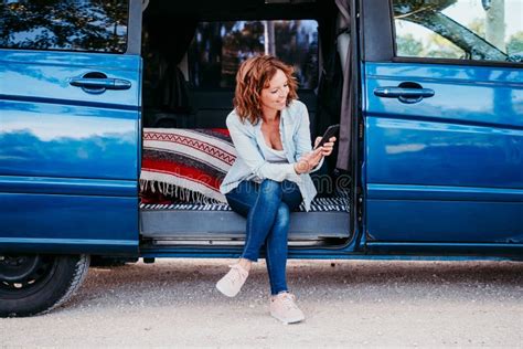 Happy Woman Sitting In A Blue Van And Having Fun Travel Concept Stock