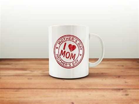 A White Coffee Mug With The Words I Love Mom On It Sitting On A Wooden