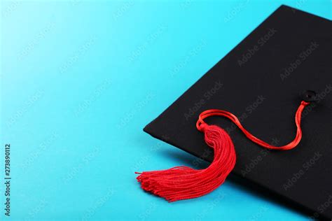 Graduation cap on blue background Stock Photo | Adobe Stock