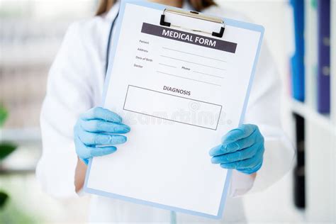 Female Doctor Hold Clipboard Pad And Fill Medical History List Stock