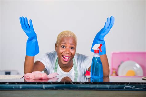 Young Beautiful And Happy African American Black Woman In Washing Rubber Clothes Cleaning Home