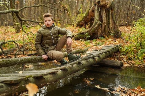 A Guy Sits On The Bridge Over The Stream Stock Photo Image Of Green