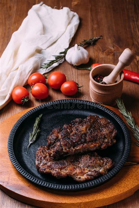 Bife Fritado Temperos Em Uma Placa Do Ferro Em Uma Tabela De