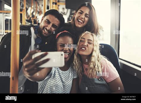 Group Of Diverse Young Friends Smiling And Taking Selfies Together