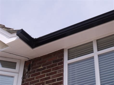 Installation of Black Seamless Aluminium Guttering With White UPVC ...