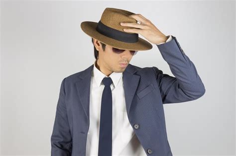 Premium Photo Midsection Of Man Wearing Hat Against White Background