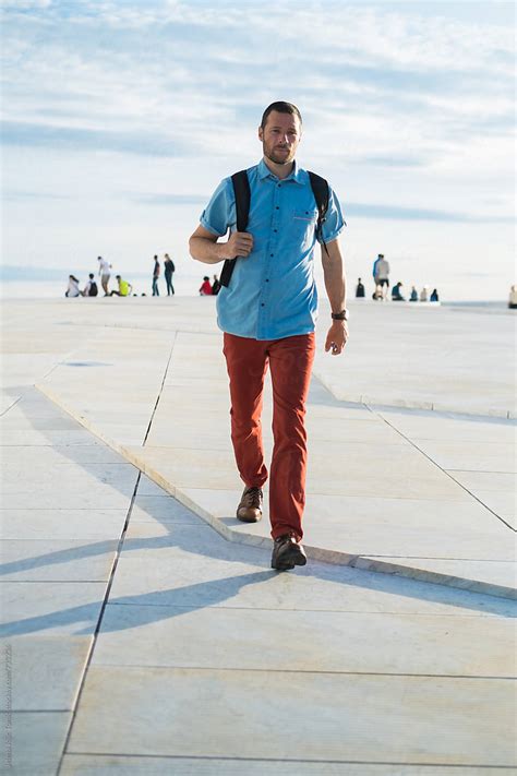 Man With A Backpack Walking On The Promenade Del Colaborador De