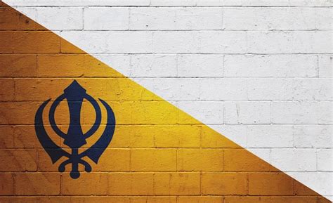 Premium Photo Flag Of Nishan Sahib Painted On A Wall