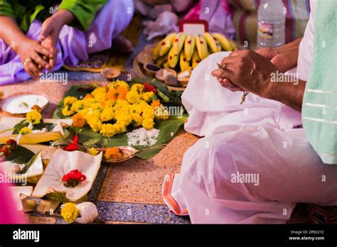 Hindu Puja Rituals Being Performed With Flowers In Front Of Priest