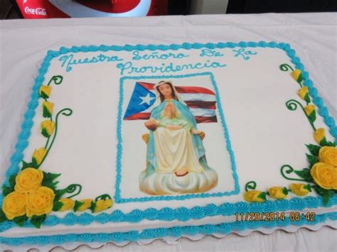 A Cake Decorated With The Image Of Our Lady Of Guadalupe Is On A White