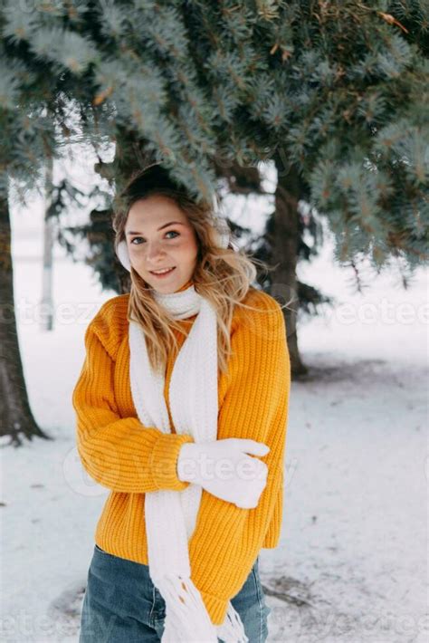 Teen Blonde In A Yellow Sweater Outside In Winter A Teenage Girl On A Walk In Winter Clothes In